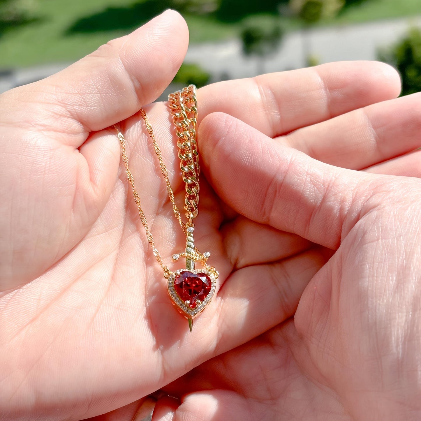 Close-up photo of Heart and Sword Necklace showing pendant and chain details
