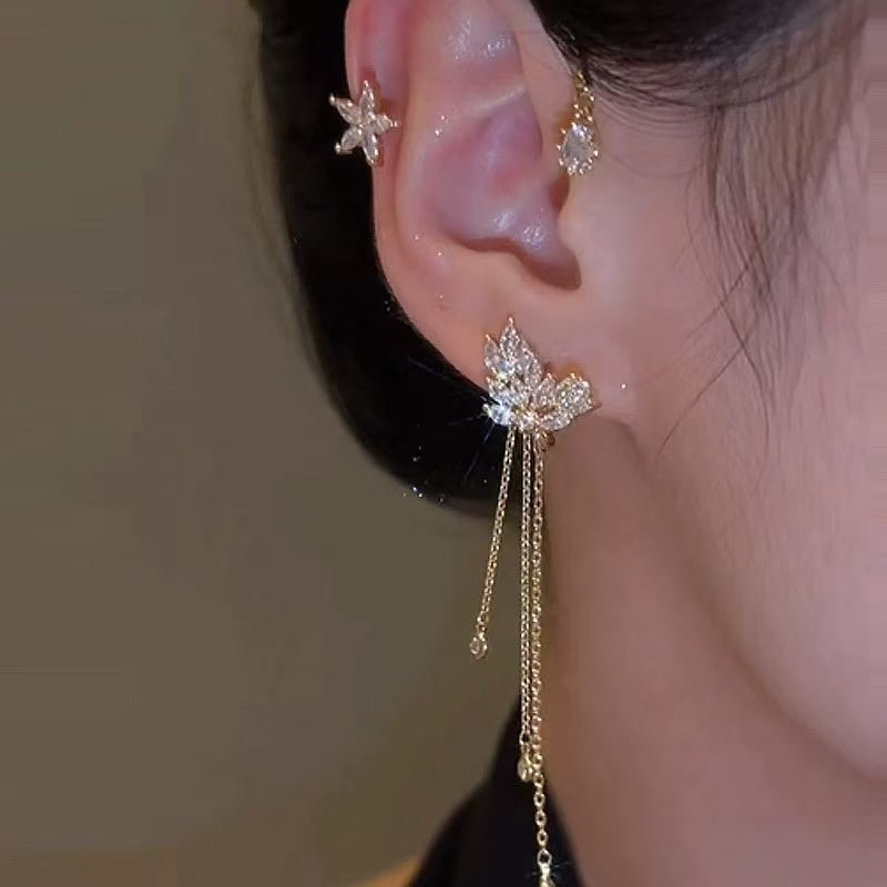 Model wearing gold butterfly ear cuff