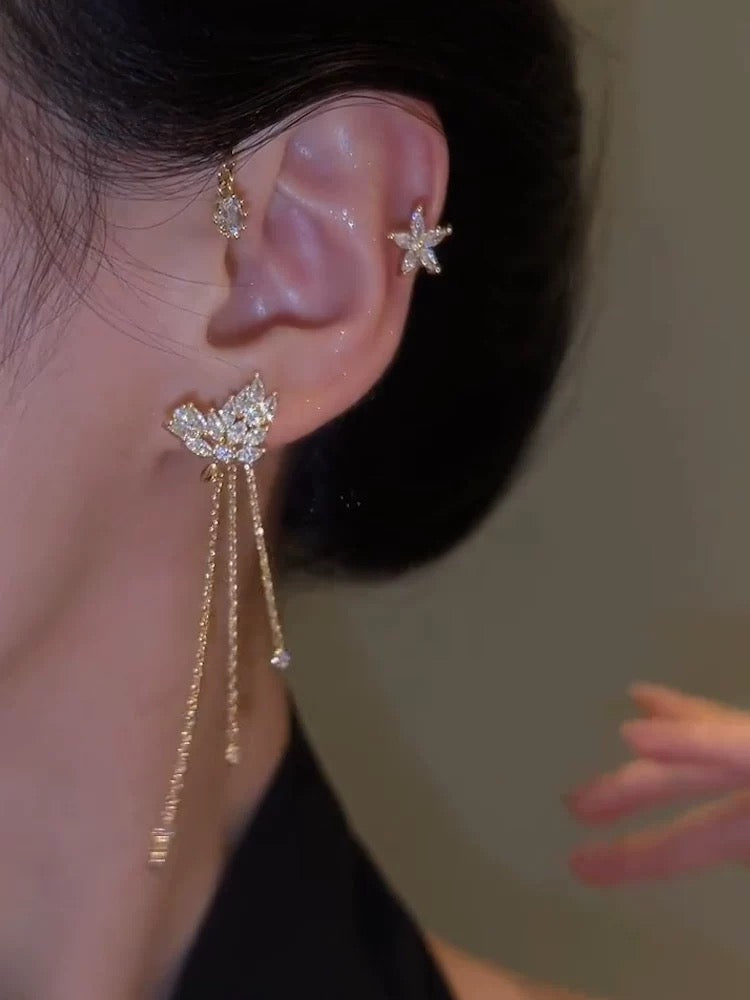 Model wearing gold butterfly ear cuff